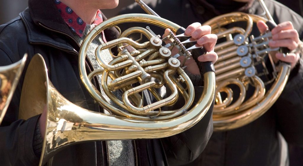 holding a french horn